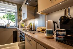a kitchen with a sink and a counter top at Old Whisky Distillery Apartment in Fort William