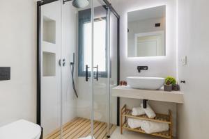 a bathroom with a glass shower and a sink at Casa Las Palmeras in Marbella +50 photos