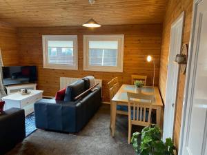 a living room with a couch and a table at Hideaway Lodge in Carnforth