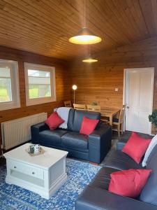 a living room with a couch and a table at Hideaway Lodge in Carnforth