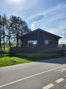 a small house on the side of a road at Hideaway Lodge in Carnforth