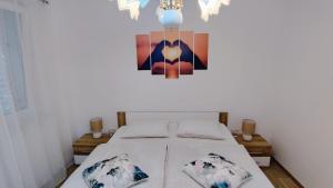 a bedroom with a bed and a painting on the wall at Vista Capodistria in Koper