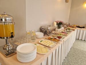 a buffet line with plates of food on a table at Poilsio namai "Vyturys" in Palanga