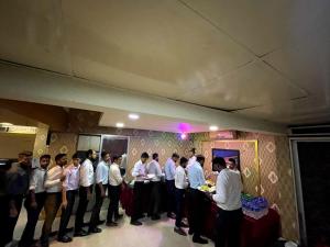 a group of men standing in a line in a room at Hotel Milina Uttara in Dhaka