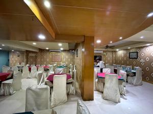 a banquet hall with tables and chairs in a room at Hotel Milina Uttara in Dhaka