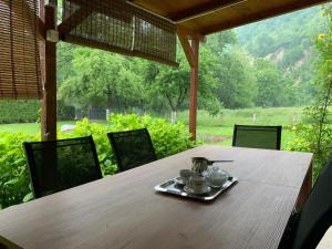 a wooden table with a plate of food on it at Holiday Residence Burić in Visoko