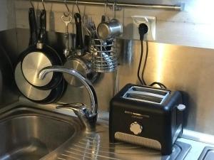 a toaster sitting on a kitchen counter next to a sink at Studio Cozy - In the Heart of Skyros Village in Skiros