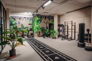 a gym with plants and a wall with a mural at Van der Valk hotel Harderwijk in Harderwijk