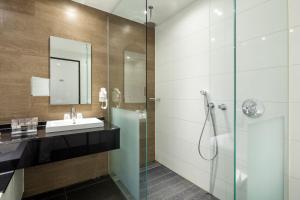 a bathroom with a sink and a shower at Van der Valk hotel Harderwijk in Harderwijk