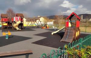 a playground with several play equipment in a park at No 14 Holiday Village House, Sneem, 4 bedrooms in Sneem