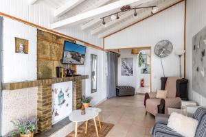 a living room with a couch and a fireplace at Beach House Cavo Kiotari in Gennadi