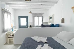 a white room with a bed with pillows on it at Lemon tree lipsi in Leipsoi
