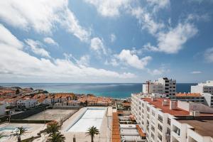 a view of a city with the ocean and buildings at Ondas do Pisão Apartment - 2 bedroom and Sea View in Santa Cruz