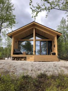 a tiny house on a hill with a large window at Chalet Luokta in Inari