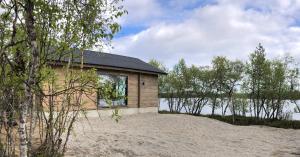 a house on the shore of a body of water at Chalet Luokta in Inari