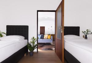 two beds in a room with a mirror at Hotel Baroko in Prague