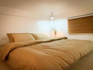 a large bed in a bedroom with a light at Ace Tiny Home in Alaminos - Home of the Hundred Islands in Alaminos
