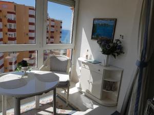 a small room with a table and a table and a window at Luxury Studio Apartment in Torrox Costa