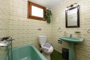 a bathroom with a green tub and a toilet and a sink at Heaven's house in Kallirákhi +31 photos
