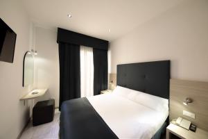 Ένα ή περισσότερα κρεβάτια σε δωμάτιο στο Hotel El Salvador Frontemare Piscina Riscaldata