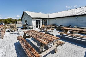 a group of picnic tables on a patio at The Piggery at Little Pig in Bude