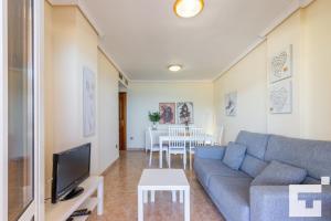 a living room with a couch and a tv at Apartamento Realet 1F - Grupo Turis in Calpe