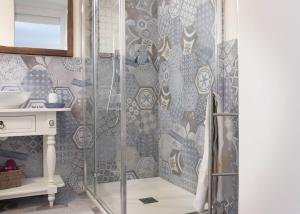 a shower with a glass door in a bathroom at Camera Astrid in Casa Alzi