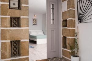 a room with a brick wall next to a door at Studio Cozy - In the Heart of Skyros Village in Skiros