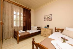 a bedroom with two beds and a window at Heaven's house in Kallirákhi