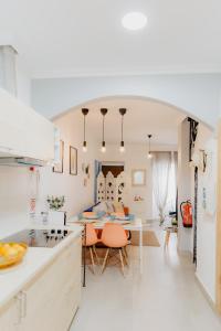 a kitchen and living room with a table and chairs at Home Santa Clara in Albufeira