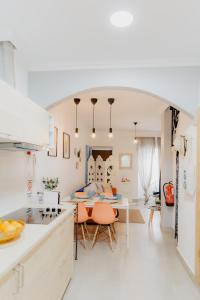 a kitchen and living room with a table and chairs at Home Santa Clara in Albufeira +32 photos