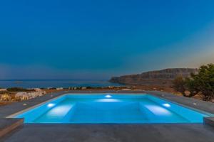 a swimming pool with a view of the ocean at Solis Lindos Villa in Lindos