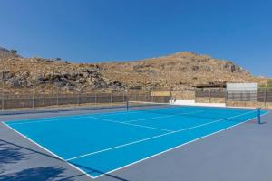 a tennis court in front of a mountain at Solis Lindos Villa in Líndos