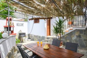 a wooden table and chairs on a patio at Heaven's house in Kallirákhi