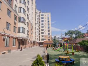 an empty street with a playground in a city at RentHouse Apartments Perla in Chişinău