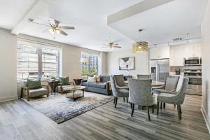 a living room with a couch and a table and chairs at Amazing 4-Bedroom Haven in the Heart of New Orleans in New Orleans
