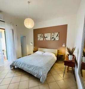 a bedroom with a large bed in a room at B&B L'albero di Melograno in Seccheto
