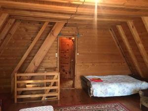 a room with a bed in a wooden cabin at Domek Basia in Deskurów