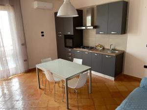 een keuken met een tafel en stoelen in een kamer bij Ribo Apartments in Angri
