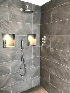 a bathroom with a shower with a shower head at Namastay at Longacre in Woodland