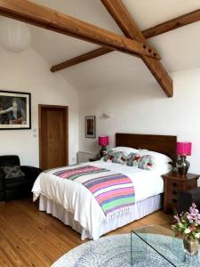 a bedroom with a large bed and a glass table at Namastay at Longacre in Woodland