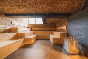 a sauna with wooden benches and a brick wall at Hotel & Wellness Royal Astrid in Ostend