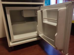 an empty refrigerator with its door open in a kitchen at Guest House Periko in Split