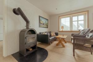 a living room with a wood stove in it at Breathtaking View / 5-BR House / Scenic Village in Bøur