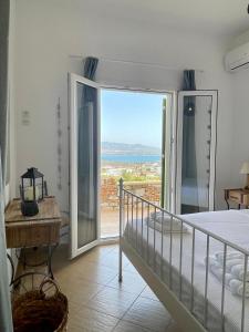 a bedroom with a bed and a view of the ocean at Gregos house in Antiparos