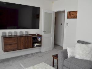 een woonkamer met een tv en een bank bij Pass the Keys Gorgeous Maisonette in Bournemouth