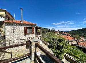 a view of a house from a wooden balcony at Katerina's Guest House in Promírion