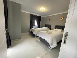 a hotel room with two beds and a window at Continental Trabzon Suite&Apartments in Trabzon