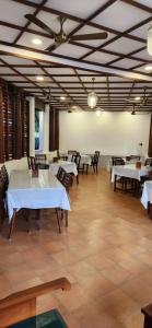 uma sala de jantar com mesas e cadeiras num edifício em Kumarakom Tharavadu - A Heritage Hotel, Kumarakom em Kumarakom