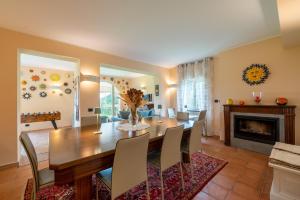a dining room with a table and chairs and a fireplace at La Vignana - 5 Terre in Levanto